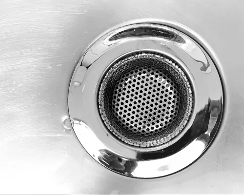 Close-up of a stainless steel sink drain