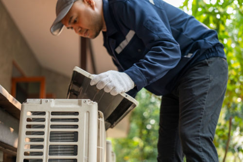 HVAC Murfreesboro TN service outdoor checking fix repair. Air conditioner cleaning technician He opened the front cover and took out the filters and washed it.